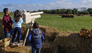 a father and children operating an apple cannon